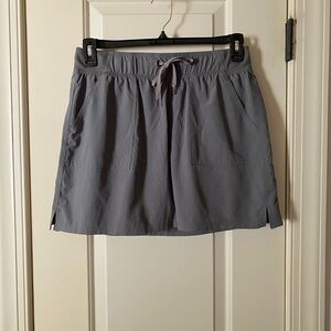 Champion green/gray sport skort.  Tag says L but fit is M. Super light worn once